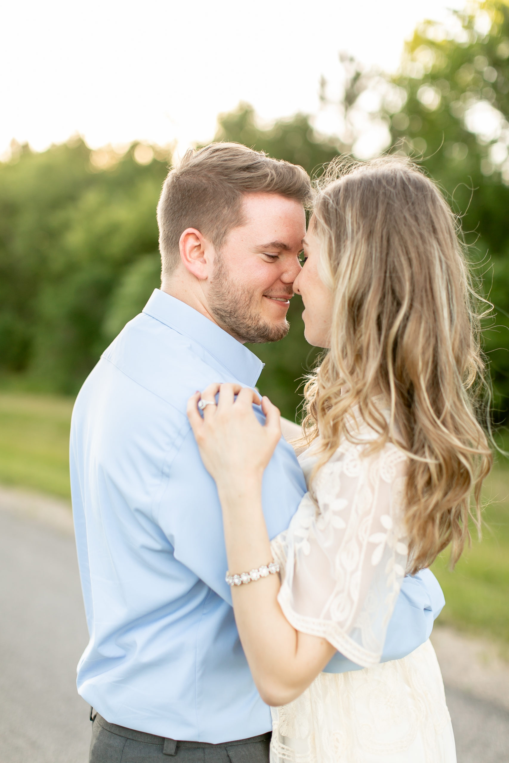 Alexandria, MN Engagement Session couple wrapped in each other's arms, heads touching, looking at each other.